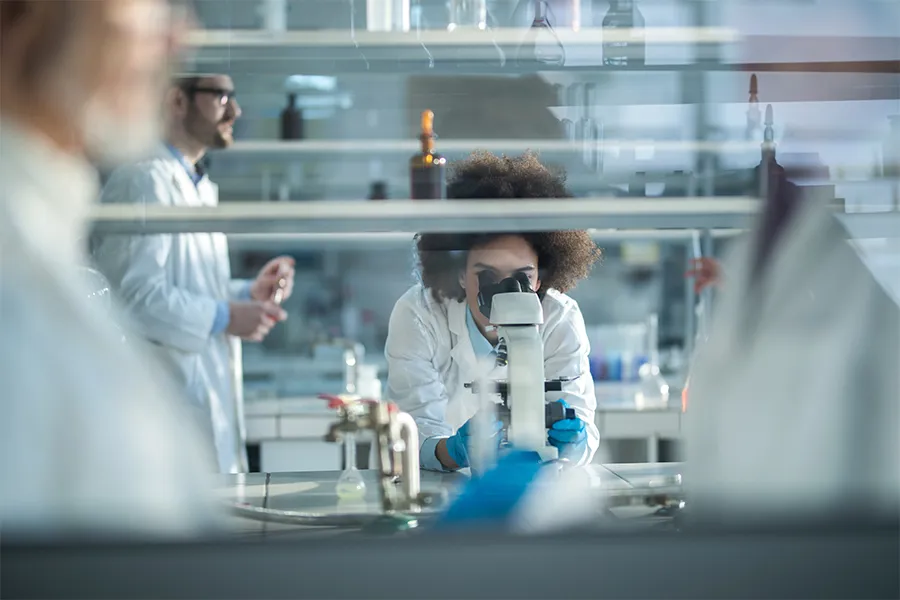 A scientist using a microscope in a laboratory setting